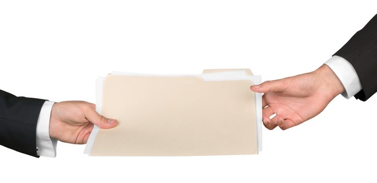 Closeup of Businesspeople Handing File Folder