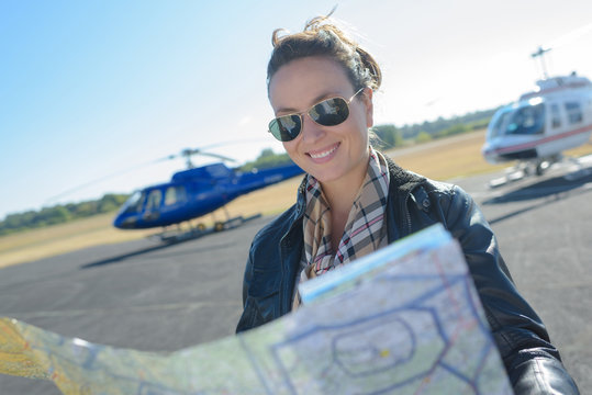 helicopter pilot looking at map on runway