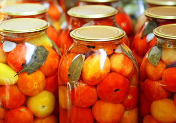 Pickled tomatoes in jars.