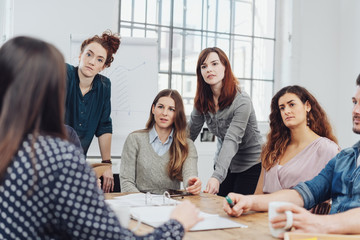 Group of young businesswomen listening attentively