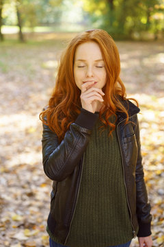 Young redhead woman pausing a moment to meditate