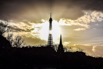 Sun burst through the Eiffel Tower