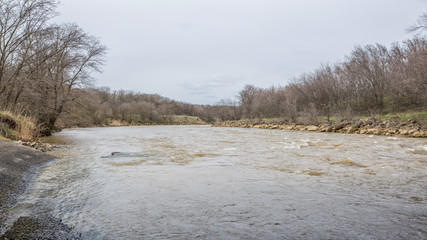 Landscape with a stormy spring river