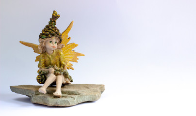 Cute spring fairy garden figurine on soft light white background