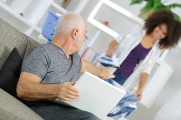 Fototapeta premium old man using laptop while talking to her assistant
