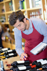handsome professional sommelier choosing a bottle of wine