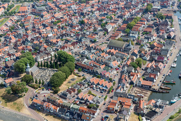 Aerial view Dutch fishing village with harbor, lighthouse and residential area