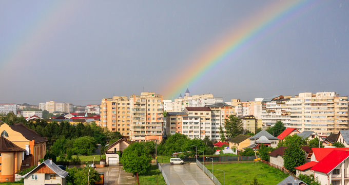 Suceava, Romania - May 26, 2018: Rainbow over Suceava city after a strong rain