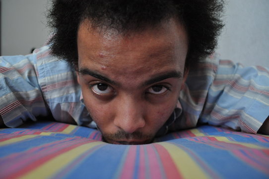 Crazy Afro Hair Guy On A Rainbow Bed