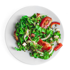 Falf plate fresh salad with tomatoes, nuts, arugula and cheese on white isolated background top view. Healthy food. Vegetarian food