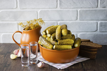 Marinated cucumbers, bacon, rye bread, onions and garlic and two glasses of vodka. Traditional Russian snack.