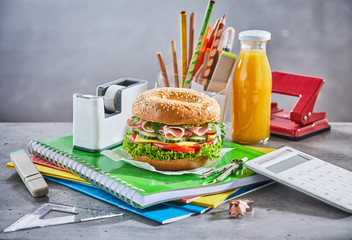 Snacks on schoolwork and surrounded by calculator