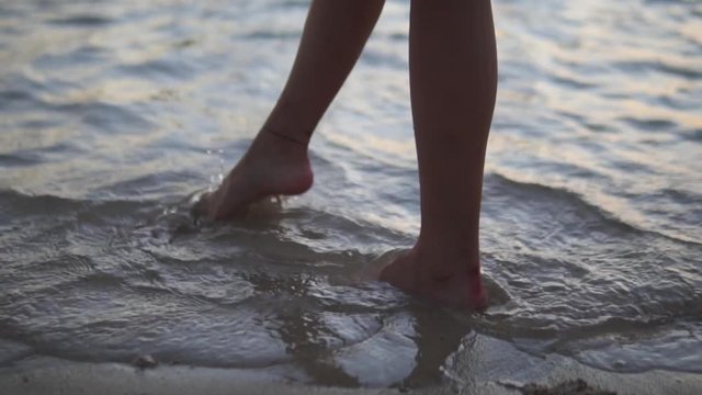 1080P Slow Motion Footage of Girl's Feet in the Sand at Sunset with Waves