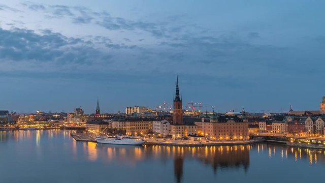 Stockholm Sweden time lapse 4K, city skyline day to night timelapse at City Hall and Gamla Stan