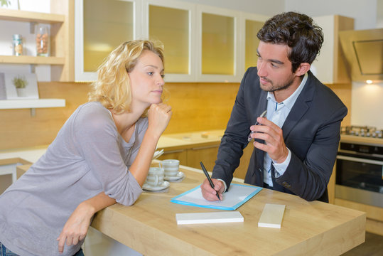 Man and lady making notes in kitchen