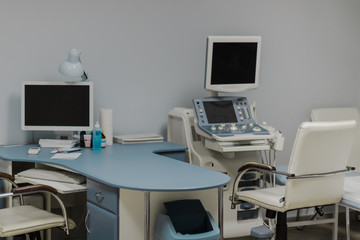 Medical office with medical equipment for ultrasonic diagnostics. Workplace of doctor and assistant.