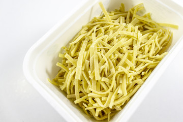 Close-up detail shot of handmade traditional pasta in white box