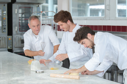 Young male chefs making pastry