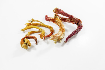 Orange and red colored peppers on white background