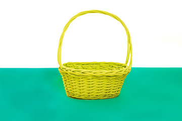 Fototapeta na wymiar Empty green yellow basket isolated on a white and green background