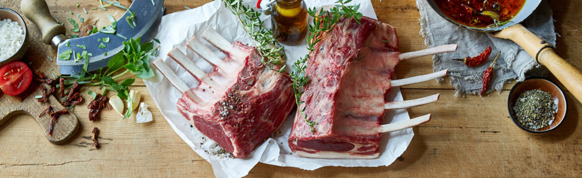 Panorama banner with two uncooked racks of lamb