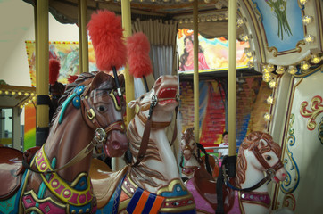 Fototapeta na wymiar Carousel in the amusement Park, children's carousel horses