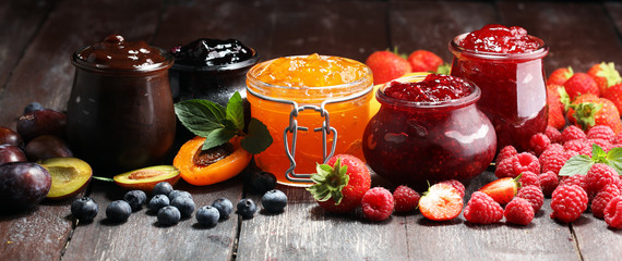 assortment of jams, seasonal berries, apricot, mint and fruits. marmalade or confiture - obrazy, fototapety, plakaty