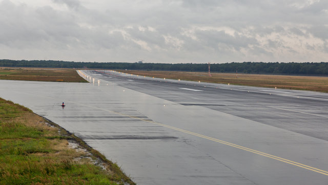 empty runway at the passenger airport in the rain