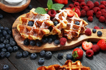 Traditional belgian waffles with fresh mint, sugar and raspberries.