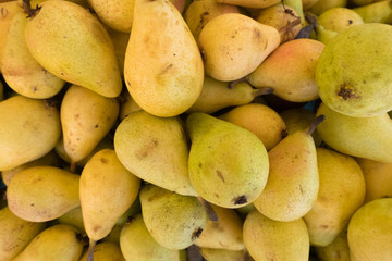 Fresh yellow pears at a street organic food market.