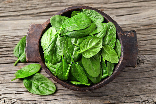 Spinach leaves on wooden background