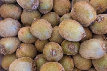 Fresh green kiwi stand at a street organic food market.
