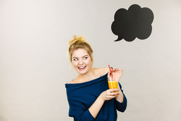 Happy woman holding fresh orange juice