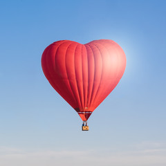 Red heart shaped air ballon isolated in the sky