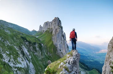 Foto auf Alu-Dibond Tourist on the high rocks background. Sport and active life concept. Adventure and travel in the mountain region in the Switzerland mountains. © biletskiyevgeniy.com
