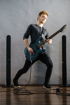 Young man playing electric guitar