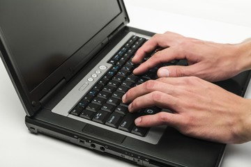 Closeup of a Person Typing on a Laptop Keyboard