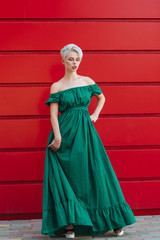 Woman with short hair in green dress. Girl in shopping. Fashion photo for shop.