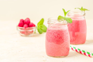 Raspberry smoothie close up photography with fresh summer blended cocktail and ripe berries.