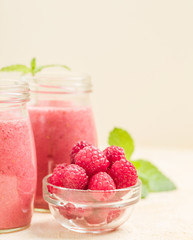 Raspberry smoothie close up photography with fresh summer blended cocktail and ripe berries.