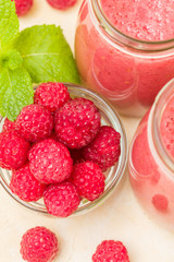 Raspberry smoothie close up photography with fresh summer blended cocktail and ripe berries.