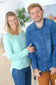 Portrait Of Couple, Man On Crutches