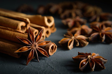  shelves of cinnamon and anise stars in dark colors on a dark concrete stone background