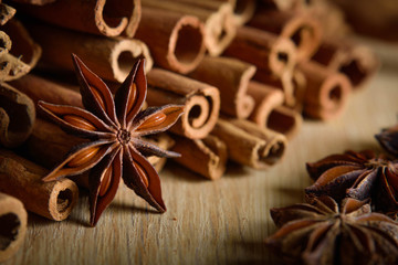  shelves of cinnamon and anise stars in dark backgrounds on a wooden background