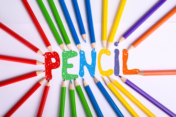  Colorful pencils isolated on white background. Top view with colored pencil caption. With copy space