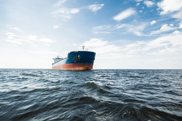 Cargo ship under the cloudy blue sky, Baltic sea, Latvia