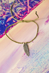 Bracelet with metal feather pendant