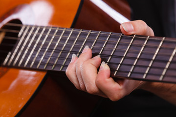 Obraz na płótnie Canvas Closeup of man playing acoustic guitar