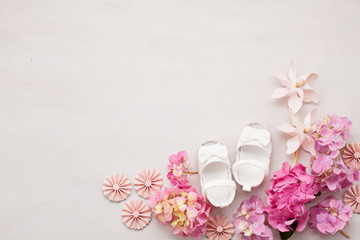 Cute newborn baby girl shoes. Baby shower, birthday, invitation, greeting card