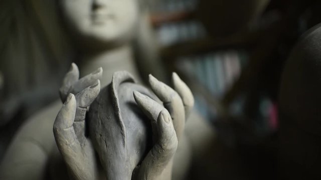 Close up of unfinished idols of Indian gods and goddesses in Kolkata, focus racking